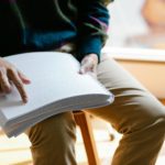 Person reading a report in braille