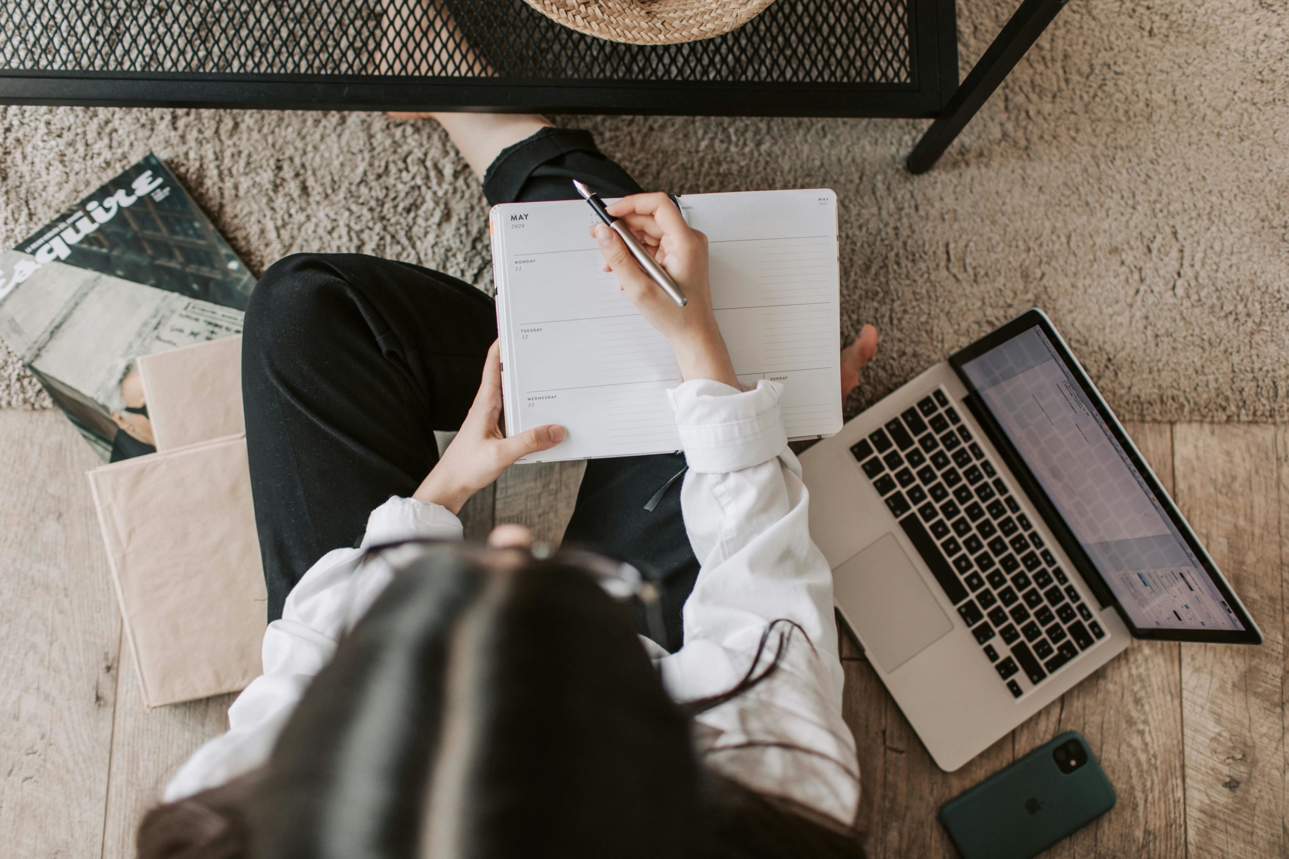 Woman sat on floor with laptop from above