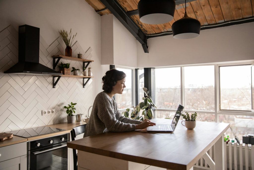 Woman on laptop in kitchen