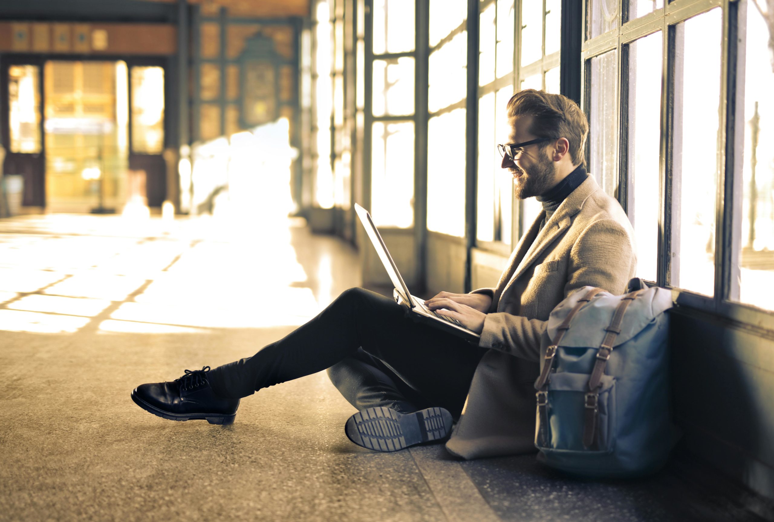 Man on laptop sat on floor